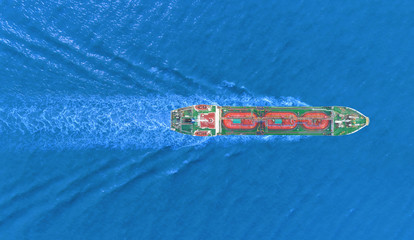 Aerial top view Ship tanker oil or gas LPG full speed with beautiful wave transportation from refinery on the sea.