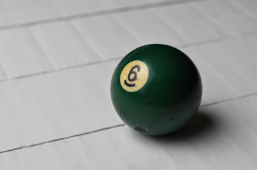 Old billiard ball number 6 green color  on white wooden table background, copy space