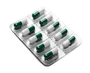 Green pills, medicine isolated on white background