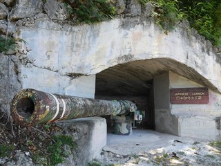 Front view of a concrete cave with an old Japanese cannon used during the world war 11, a roadside attraction in Songsong, Rota, Northern Mariana Islands