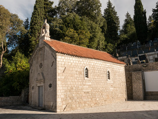 Fototapeta na wymiar Small christian church white stone chapel side view