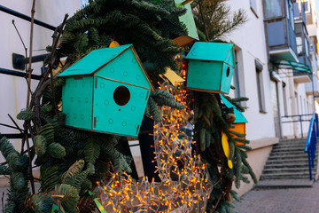 Wooden green bird feeders on the tree. Eco (natural) house.