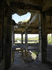 Close view of the holes in the concrete roof left from the bombs dropped at the Japanese Air Command building at the Tinian Northfield, Northern Mariana Islands 