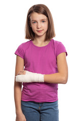 Girl teenager with a bandaged arm with plaster, isolated on white background, vertical