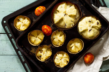 Preparation for baking, Easter raw bread. Easter cake and painted eggs on wooden table in rustic style.