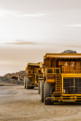 Mining dump trucks transporting Platinum ore for processing