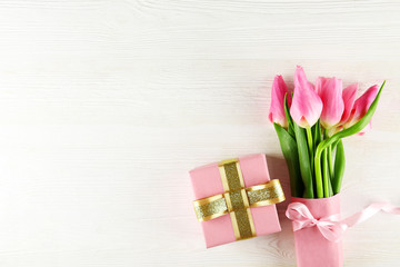 Fresh flower composition, bouquet of bi color pink tulips, white wooden texture table background. International Women's day, mother's day greeting concept. Copy space, close up, top view, flat lay.