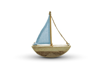 Wooden toy yacht with blue sails. Ornamental wooden yacht. House ornament. Trinket. White...