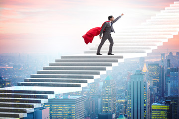 Superhero businessman climbing career ladder