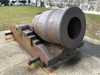 Medium wide shot of a cannon at Fort Charlotte overlooking the harbor in Nassau,Bahamas. Fort Charlotte is a British-colonial era fortress built in 1789 by Lord Dunmore.