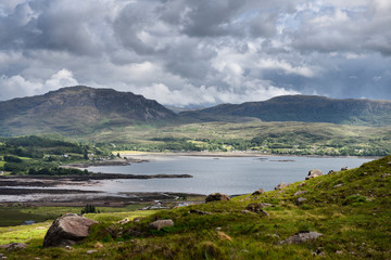 Road up to Bealach na Ba mountain pass with Loch Kishorn and Cearcall Dubh and An Sgurr peaks Scottish Highlands Scotland UK