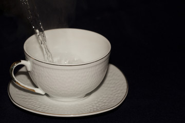 A mug of tea with lemon and chocolate.