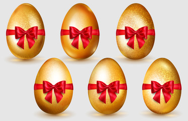 Set of realistic golden Easter eggs with red bows, glares and soft shadows on white background