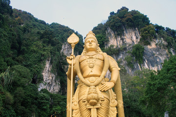 Fototapeta na wymiar The Batu Caves Lord Murugan Statue and entrance near Kuala Lumpur Malaysia.