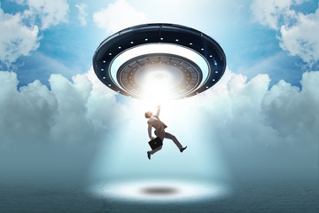Flying saucer abducting young businessman 