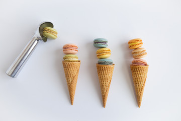 Colorful macaron cookies in sugar ice cream cones