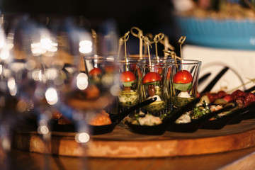 Fototapeta na wymiar Food snack tray holiday buffet table served by different canape, sandwiches, snacks, nuts, peanuts ready for eating in restaurant