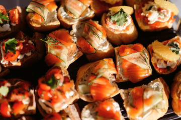 Food snack tray holiday buffet table served by different canape, sandwiches, snacks, nuts, peanuts ready for eating in restaurant