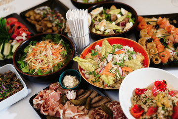 Food snack tray holiday buffet table served by different canape, sandwiches, snacks, nuts, peanuts ready for eating in restaurant