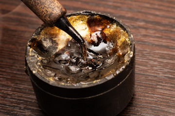 Soldering iron tip and solder flux close up