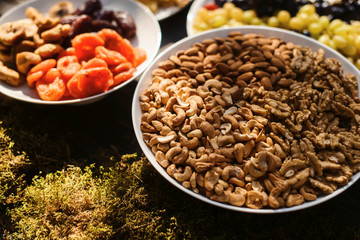 Food snack tray holiday buffet table served by different canape, sandwiches, snacks, nuts, peanuts ready for eating in restaurant