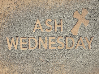 Ash Wednesday concept - Ash Wednesday words and a cross formed out of ashes.