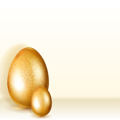 Two golden Easter eggs with soft shadows standing on light background