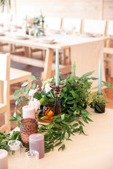 Candles and green eucalyptus on the table