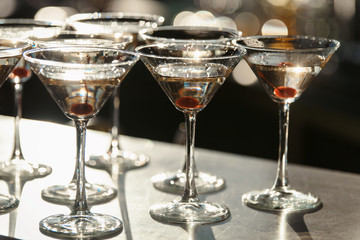 Glasses with champagne with cherry and steam from dry ice at the event. Catering concept