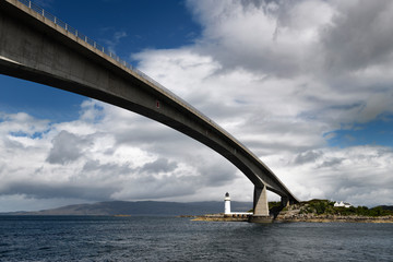 Skye Bridge over Kyle Akin Channel of Inner Sound to Loch Alsh and Eilean Ban Island with white Kyleakin lighthouse and cottages Scotland