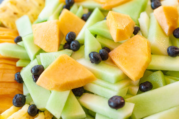 Cut cantaloupe, honeydew and blueberries