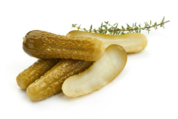 Sliced Marinated pickled cucumbers, gherkin, salted cornichon, close-up, isolated on white background