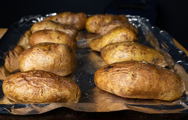 Baked potatoes on a foil lined tray