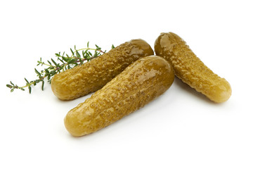 Marinated cucumbers, pickles or gherkin, salted cornichon, close-up, isolated on white background