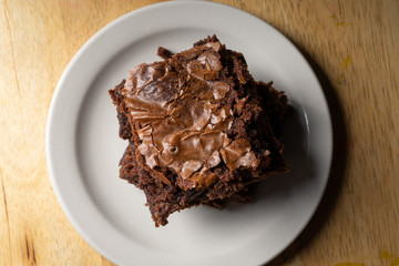Overhead view of brownies on a white plate