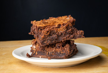 Brownies stacked on a white plate