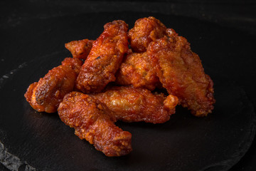 Spicy Wings on black background. Snack to beer. Fast food.