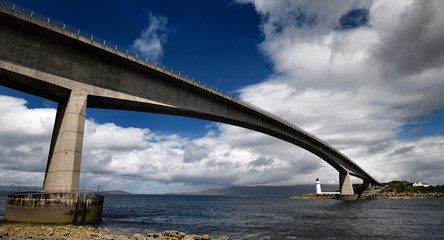 Fototapeta premium Skye Bridge to Isle of Skye over Kyle Akin Strait from Inner Sound to Loch Alsh and Eilean Ban Island with white Kyleakin lighthouse Scotland