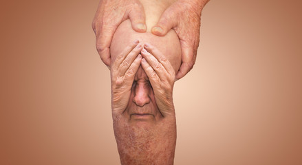 Fototapeta premium Senior man holding the knee with pain. Collage. Concept of abstract pain and despair.