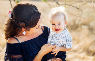 Fototapeta premium Portrait of a young mother with his son