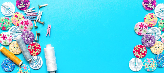 sewing thread set of sewing supplies in knolling pattern on light blue background flat lay top view, template mockup hand made long banner