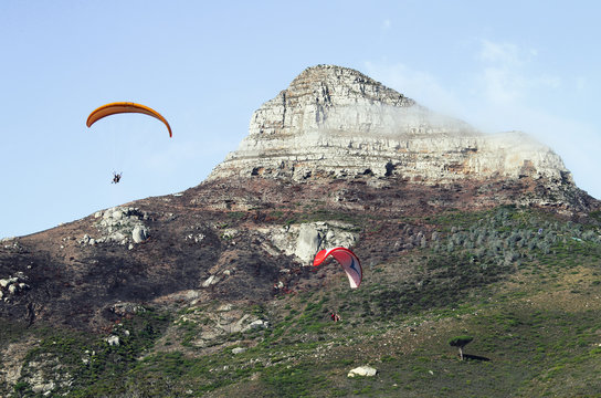 People paragliding from Lion's Head mountain in Cape Town, South Africa