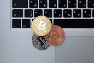 Gold currency bitcoin currency on keyboard laptop computer, electronic finance concept. Bitcoin coins. Bussiness, commercial, exchange.