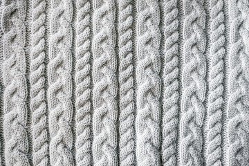 Knitted background. Knitted texture. A sample of knitting from wool. Knitting Pattern.