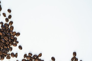 Pile of coffee beans close-up isolated on white background