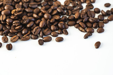 Pile of coffee beans close-up isolated on white background