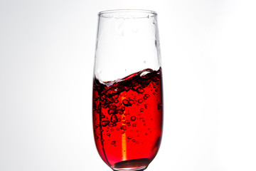 Pouring red wine isolated on white