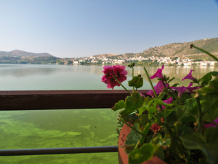 View of lake orestiada in Kastoria, Greece. Photo from a cafe  by the lake, in beautiful day light.
