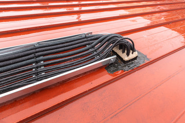 Cable tray outside with telecommunications cables, optic fiber, power cables and transmitter data...