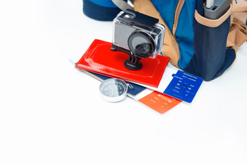 Time to Travel. Idea for tourism with action camera, plane tickets with a passport and compass. Concept on white background and backpack with portable charging.